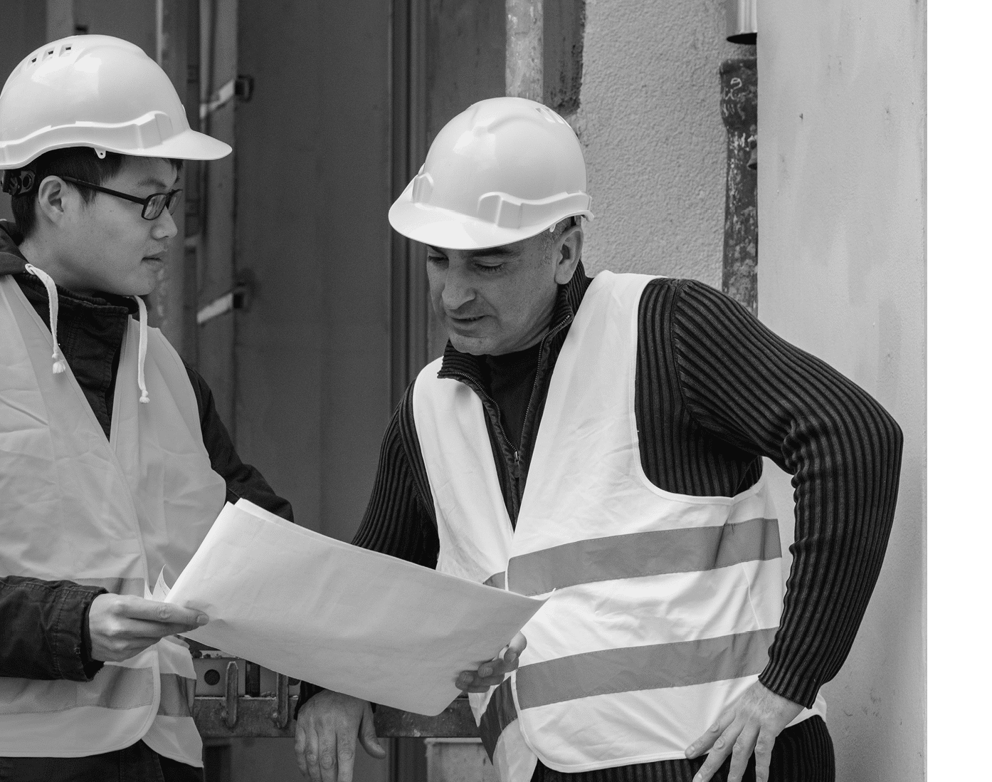 Young Asian apprentice at work on construction site with senior engineer  Outdoors