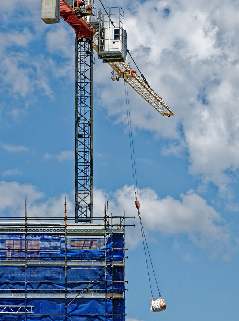 A tower crane working in high winds on new home units building site at 47 Beane St, Gosford, New South Wales, Australia - November 8  2018: Construction and building progress update ne150