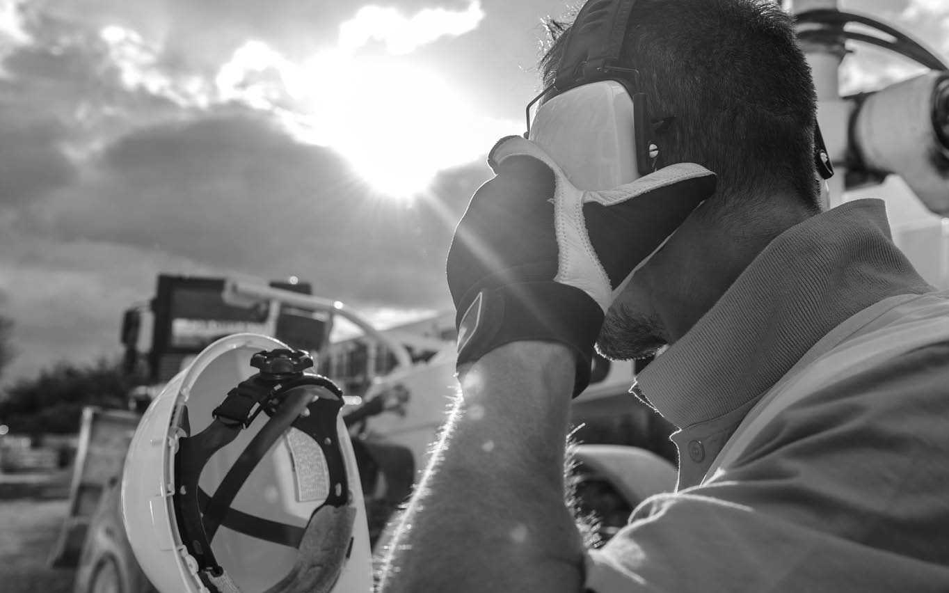 Construction Noise  Heavy Machinery Operator with Noise Reduction Headphones on His Head  Industrial Concept 