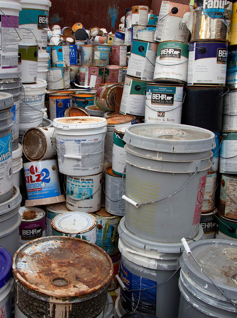 FAIRFAX, VA - DECEMBER 5: A collection of different sizes paint cans, glue buckets, mastic and toxic and hazardous material stacked at a recycling facility on December 5, 2013 in Fairfax, VA 